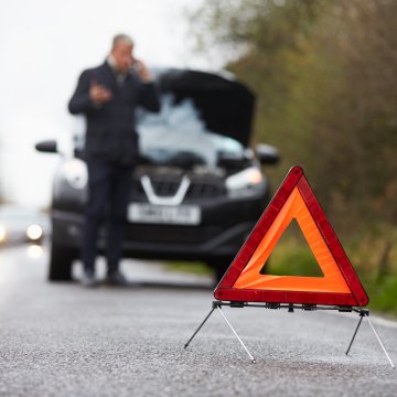 best extended car warranty services autopom! man in black on the phone red car triangle car breakdown   